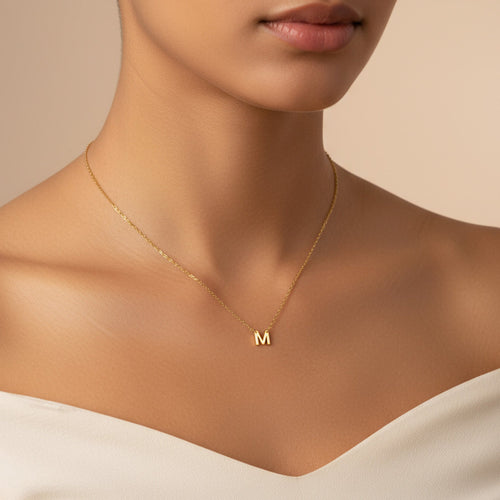 Gold dainty single initial necklace on model — minimalist letter pendant
