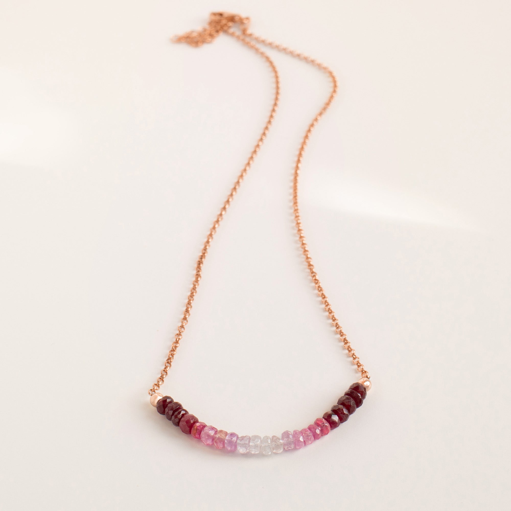 Ombré Ruby Necklace in 18K rose gold vermeil with small pink, red, and clear beads in a gradient centre — Abiza.